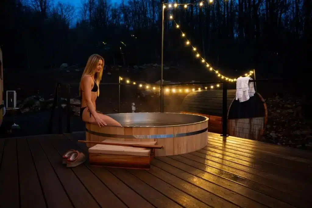 Couples hot tub retreat with string lights on wooden deck at dusk in Shenandoah Valley