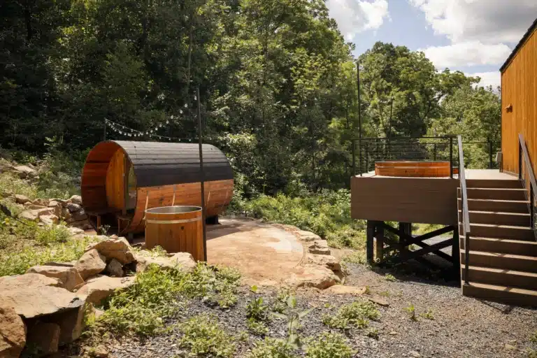 Luxury a frame cabin outdoor spa with barrel sauna and hot tub in wooded setting at Royal Oak Retreat