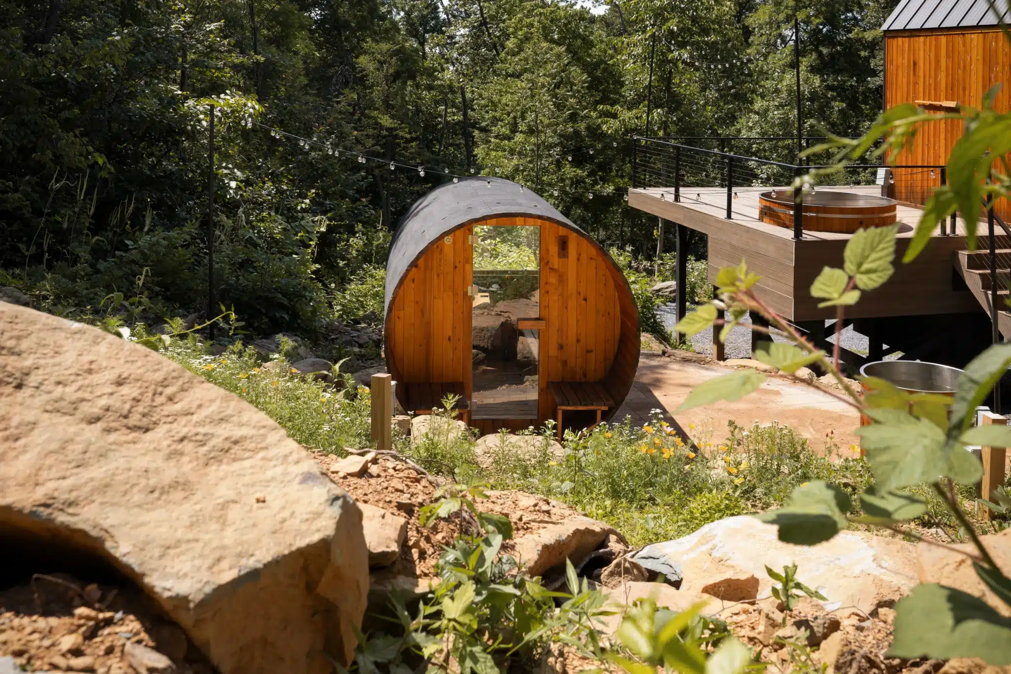 Barrel-shaped glamping pod with copper exterior nestled in lush forest at Royal Oak Retreat in Shenandoah Valley