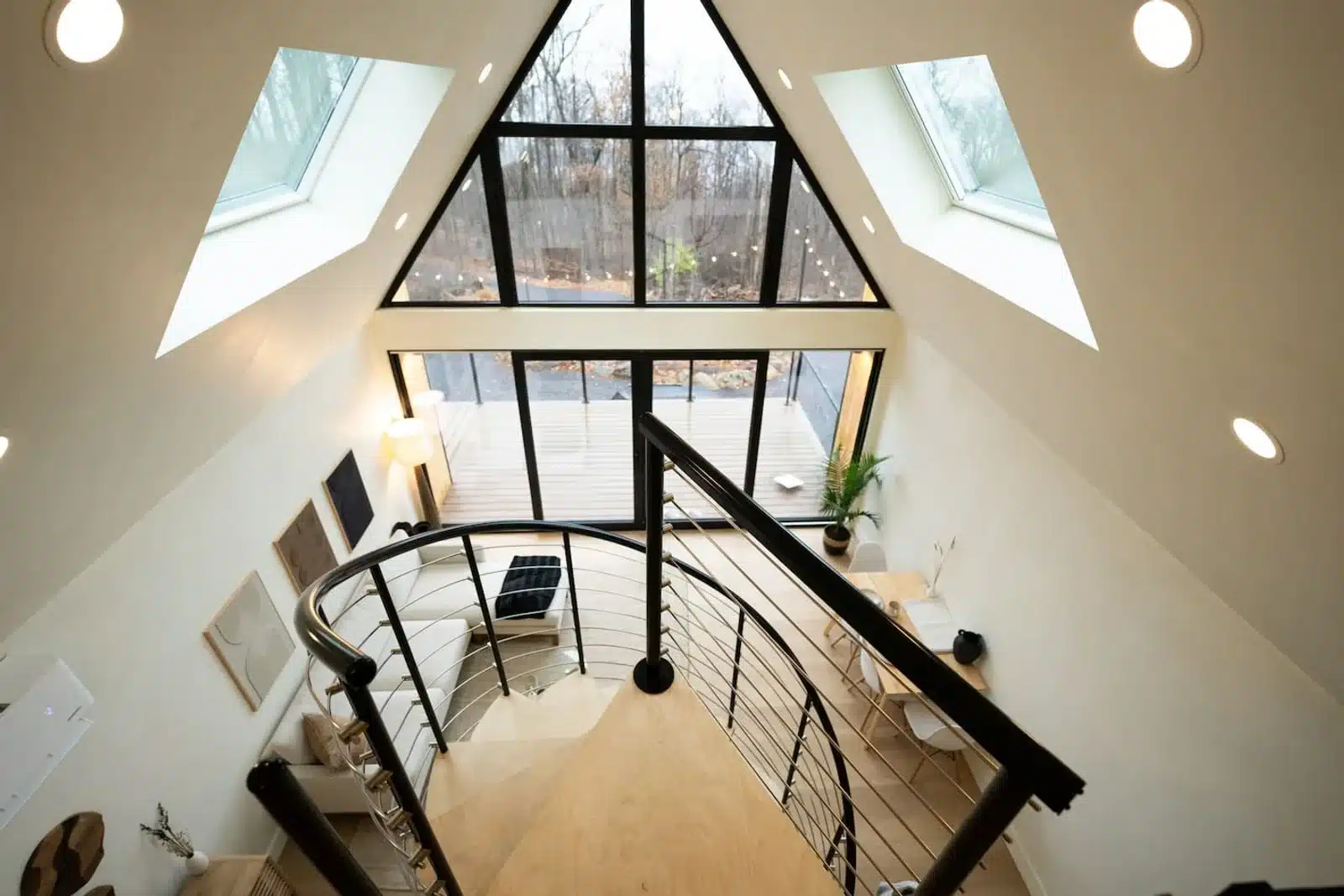 Modern staircase with black railings and forest view at Royal Oak Retreat in Shenandoah Valley