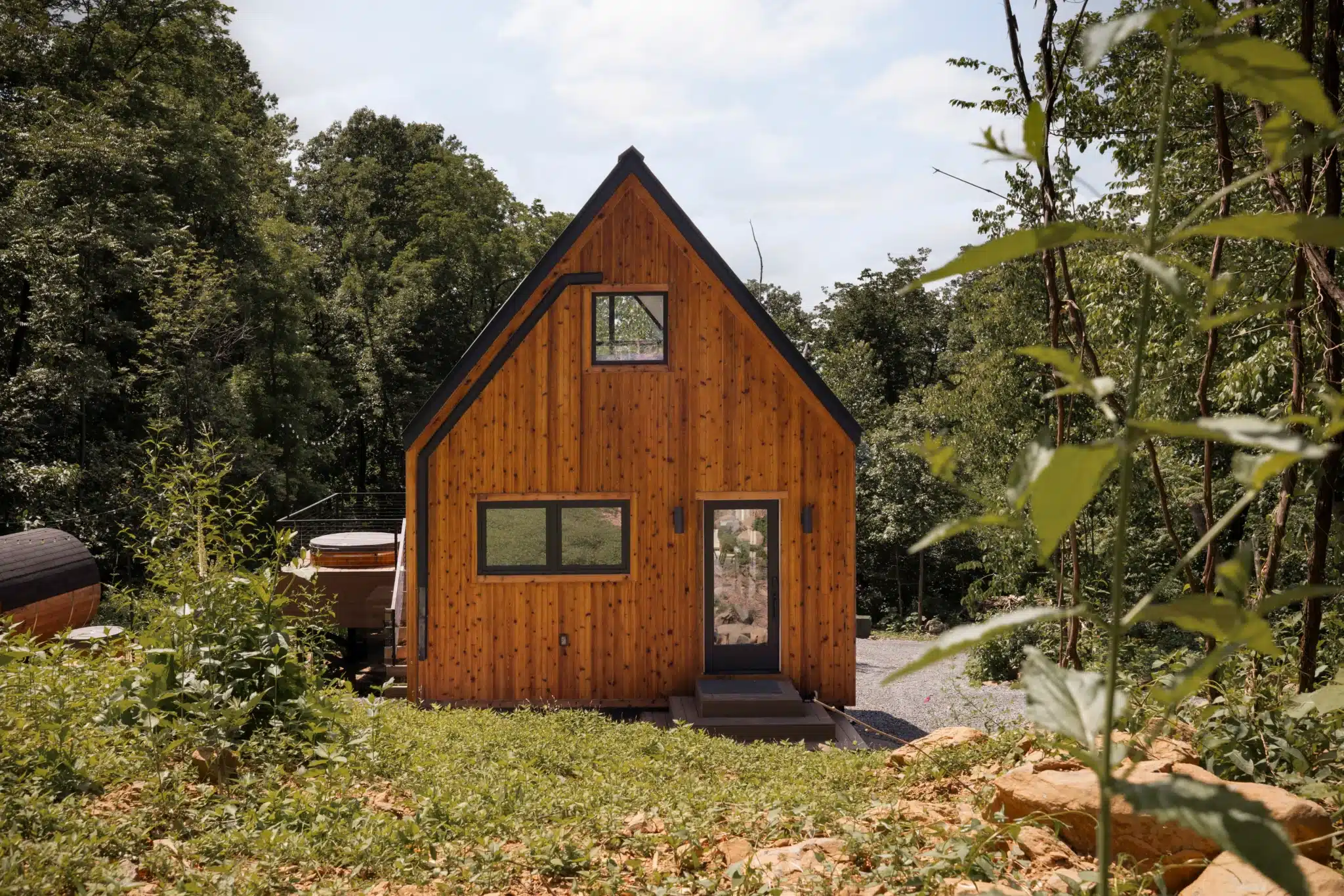 Modern A-frame cabin with wood siding in forest at Royal Oak Retreat near Front Royal Virginia