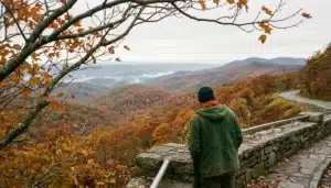 Hiker overlooking peak fall foliage on Skyline Drive in Shenandoah Valley, Virginia