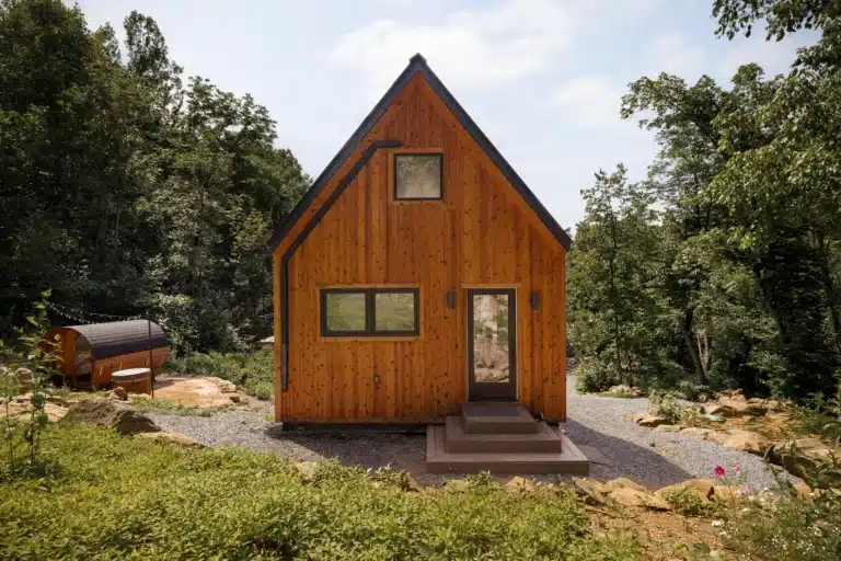 Modern tiny house with wood siding nestled in woods at Royal Oak Retreat Virginia horse country romantic getaway
